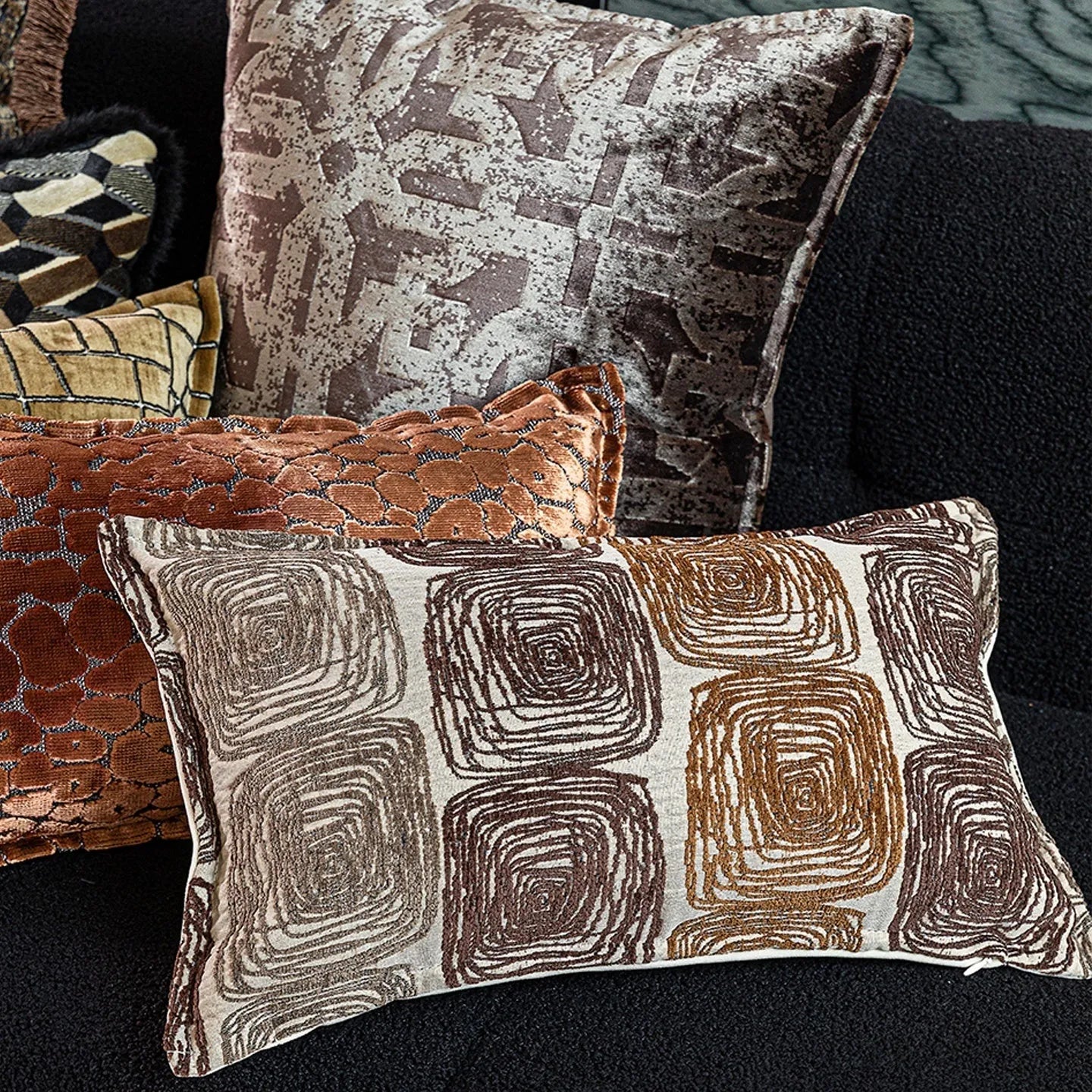 Abstract coil pattern cushion cover in cream and coffee colours, shown in square and rectangular sizes