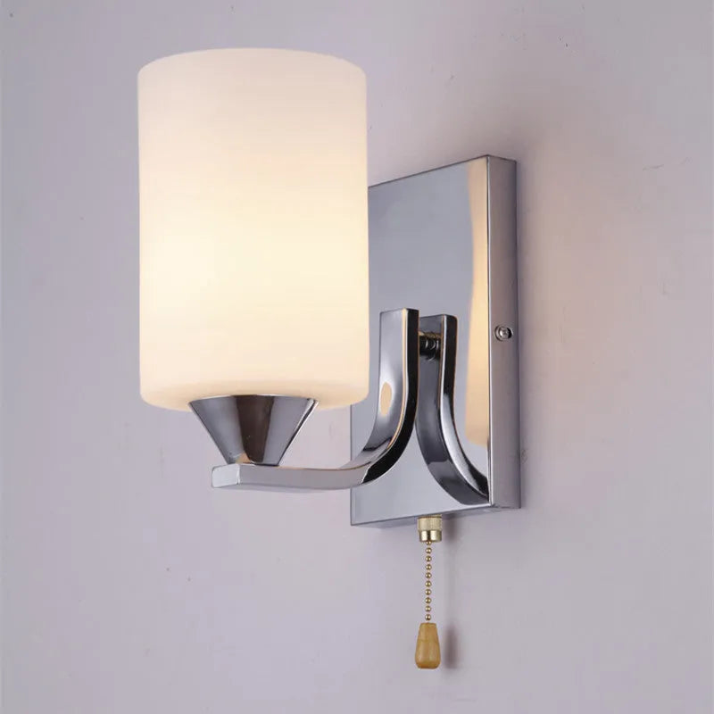 Chrome electroplated wall lamp with glass shade showing single head bedside lighting fixture