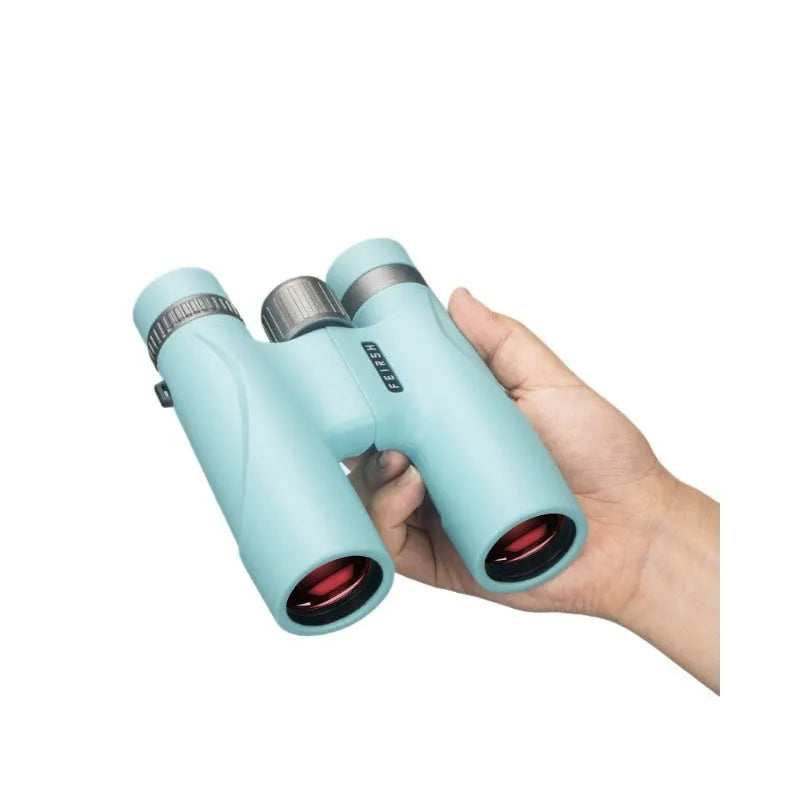 Close-up of grey 10x32 compact binoculars with wine red film lenses on a textured background.