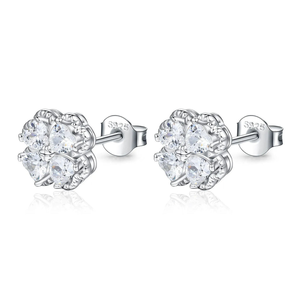 Close-up of women's 925 silver drop earrings with a four-leaf clover charm and heart zircon, in white gold colour.