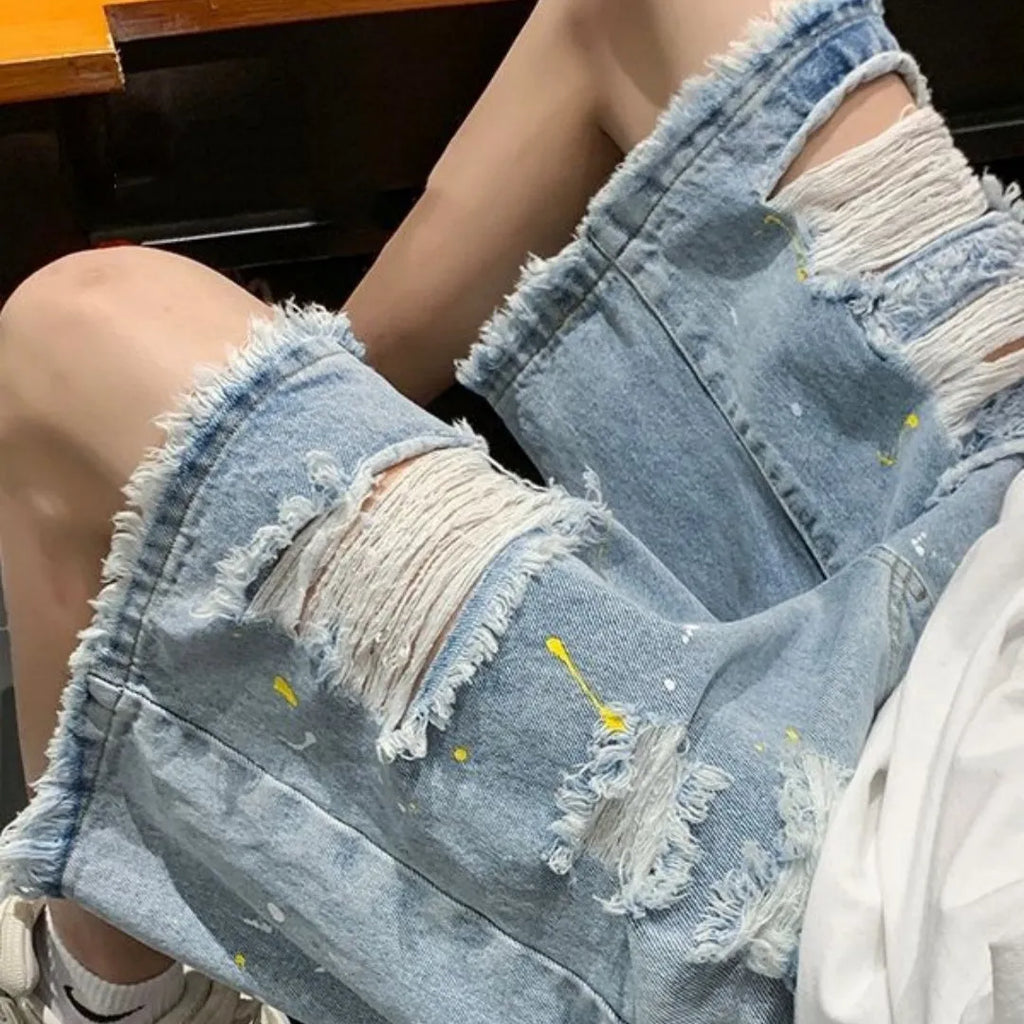 Men's loose-fit denim shorts with water washed hole detail in light blue colour.