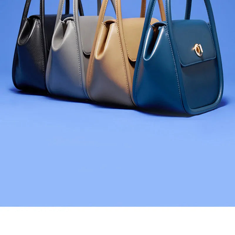 Women's wing-shaped cow leather tote handbag with a buckle closure in a choice of four colours.