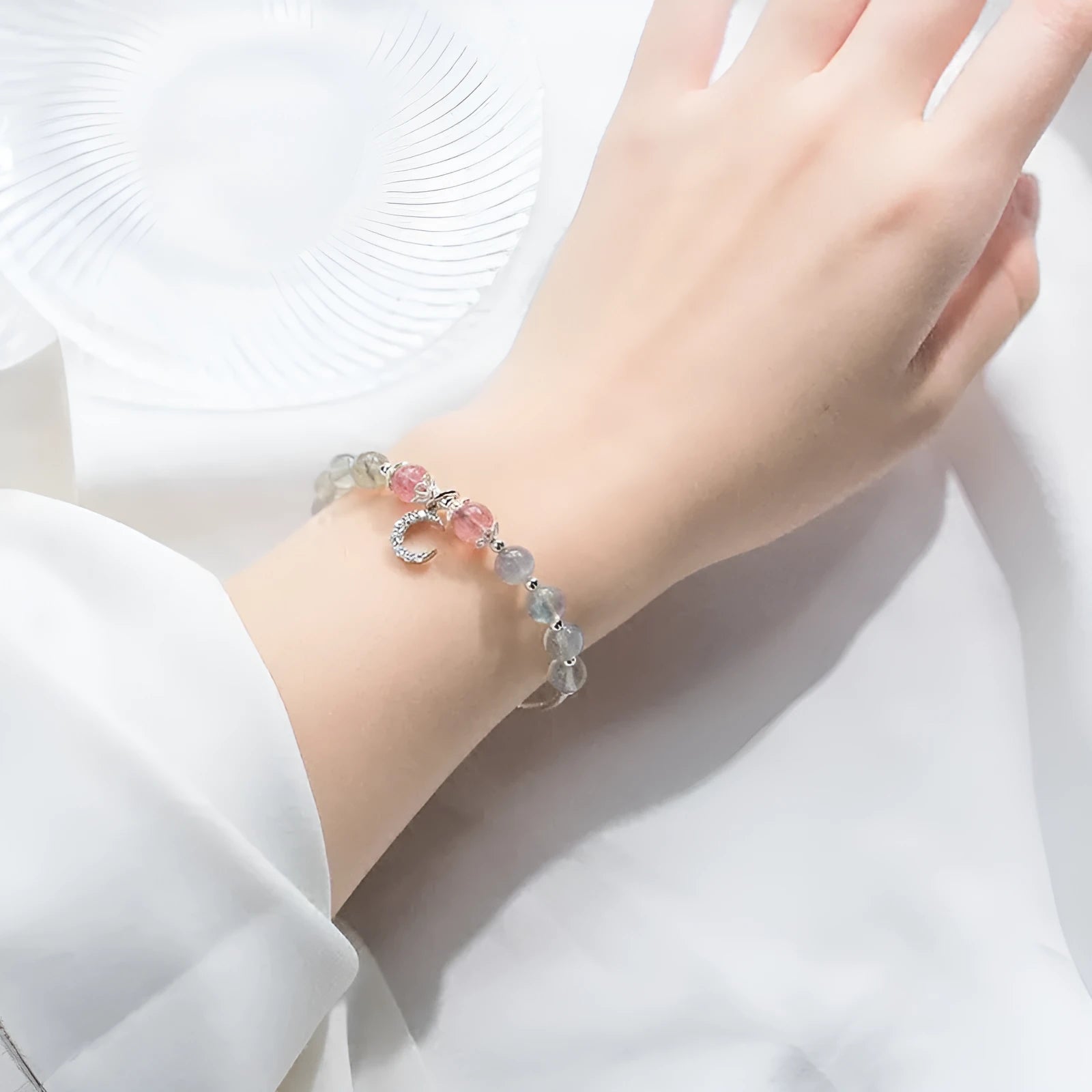 Natural moonstone adjustable bracelet with crescent moon charm and crystal accent on wrist
