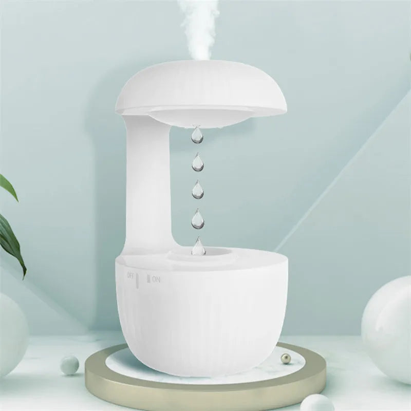 White anti-gravity air humidifier with ultrasonic mist levitating water drops on a desk
