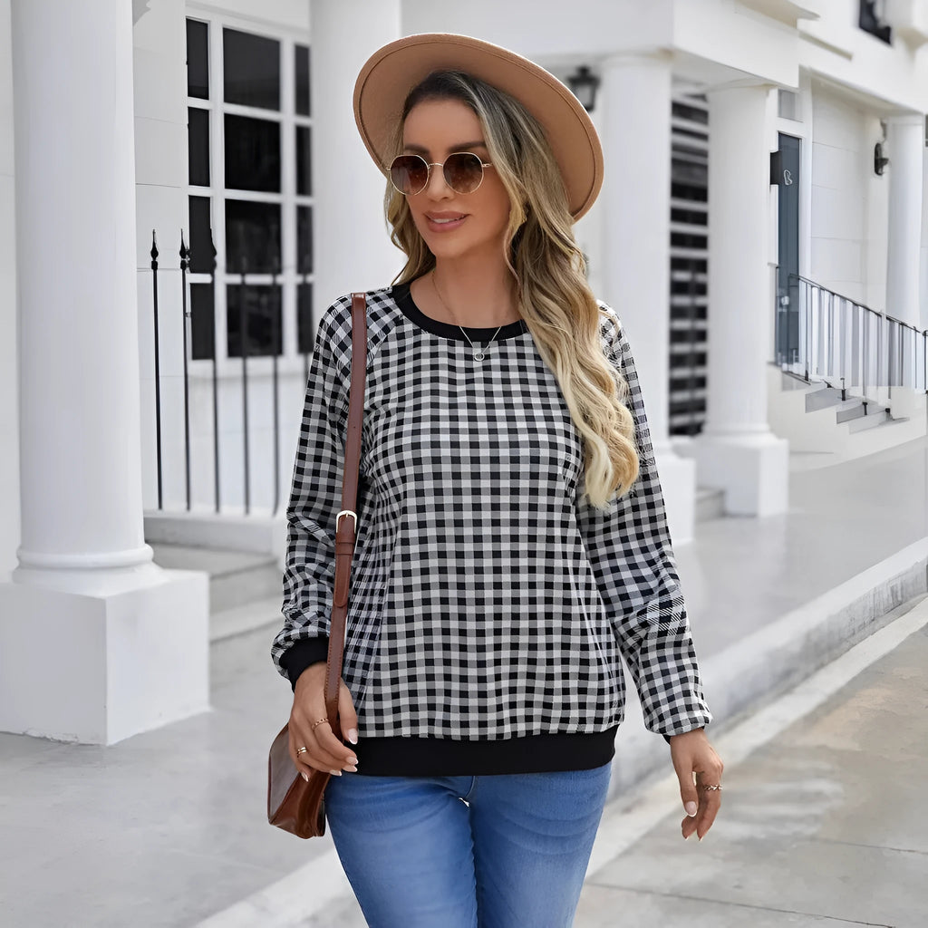 Black long sleeve pullover sweater with printed plaid and stripe pattern design.