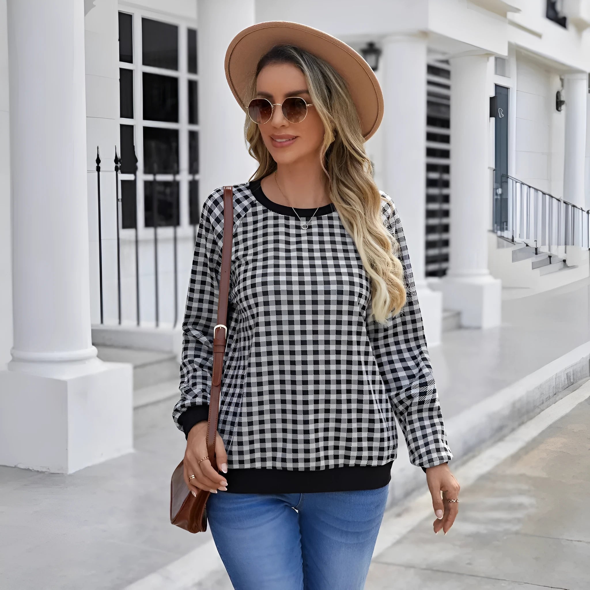 Black long sleeve pullover sweater with printed plaid and stripe pattern design.