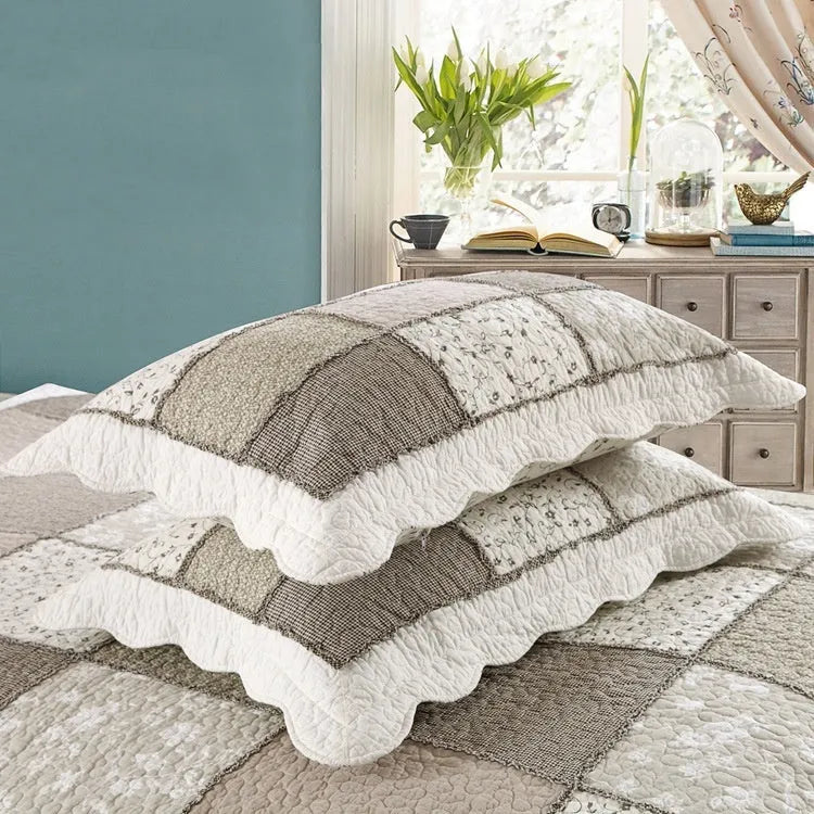 Washed pure cotton quilted bedspread and pillowcase set in a beige colour on a bed.