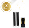 Set of four black LED taper candles with realistic 3D flame effect on wooden surface
