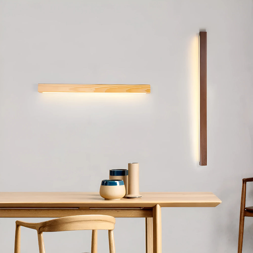 Modern walnut-colour wooden log strip LED wall lamp mounted on a wall.