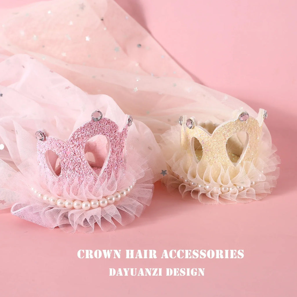 A beige and a pink princess crown headdress for cats on a white background.