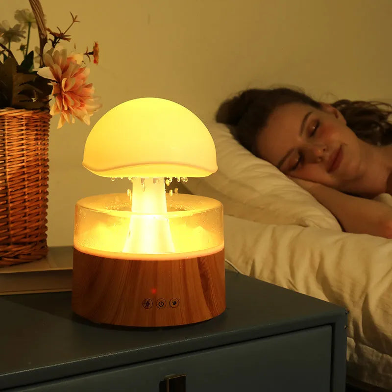 White cloud-shaped humidifier with falling water droplets and coloured night light