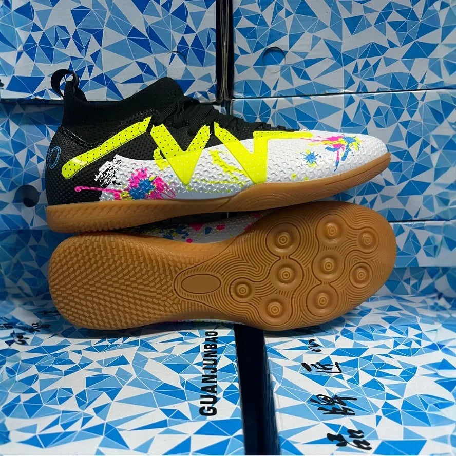 Low-top football shoes in black and yellow colour with PVC upper and rubber sole