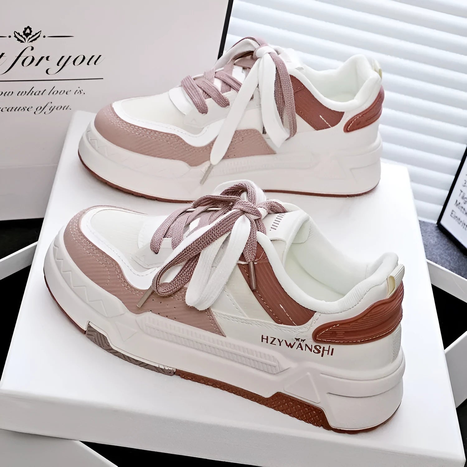 Children's beige height increasing trainers with thick rubber sole, lace-up front, and cross shoulder straps.