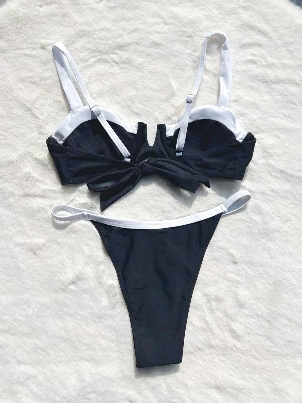 Black low waist women's bikini swimsuit with stitching split detail on the pants.