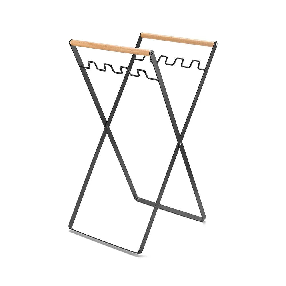 Black outdoor iron trash hanger with wooden handle in a folded position.