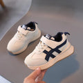 Children's solid-colour Velcro sneakers in synthetic leather with a rubber sole.