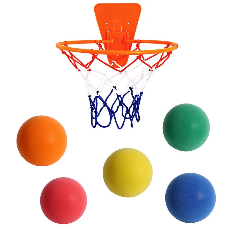 Assorted bright silent foam basketballs in different sizes next to a basketball hoop frame.