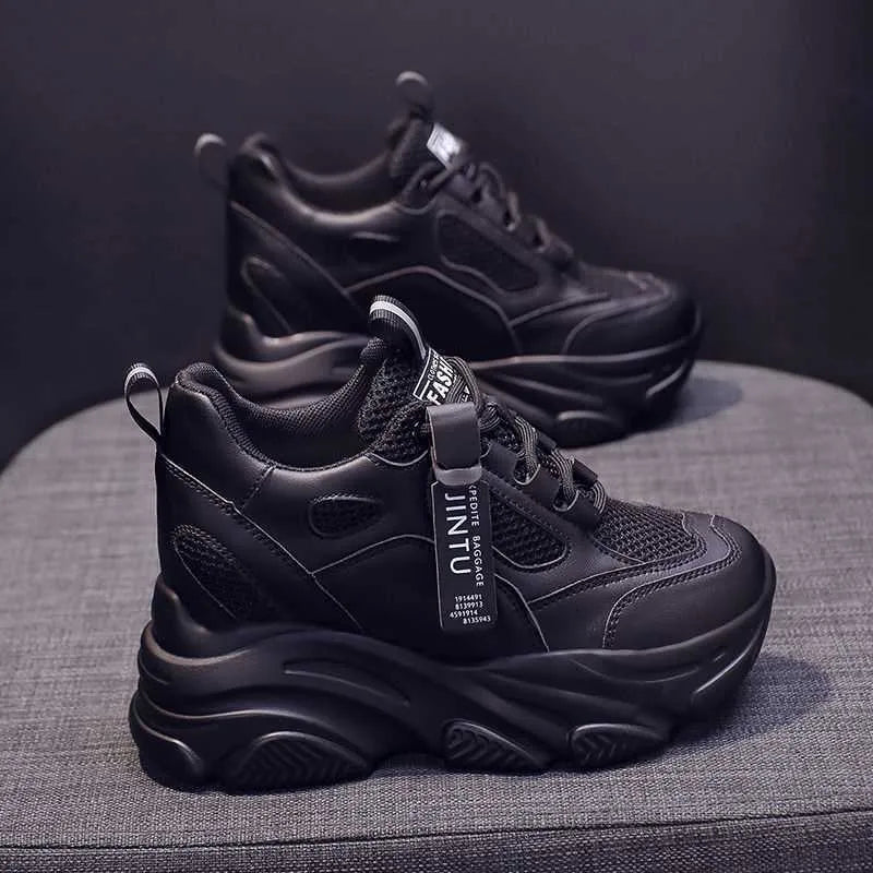 Women's black mesh platform shoes with a hollow-out design and a velvet lining on display.