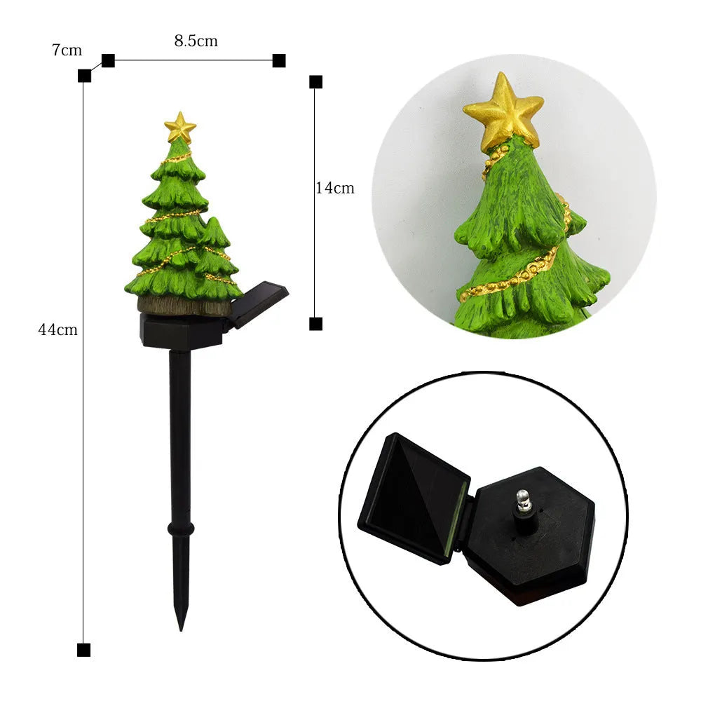 Solar Christmas tree ground plug light with resin body, warm white LED, and 40x40mm solar panel on a lawn