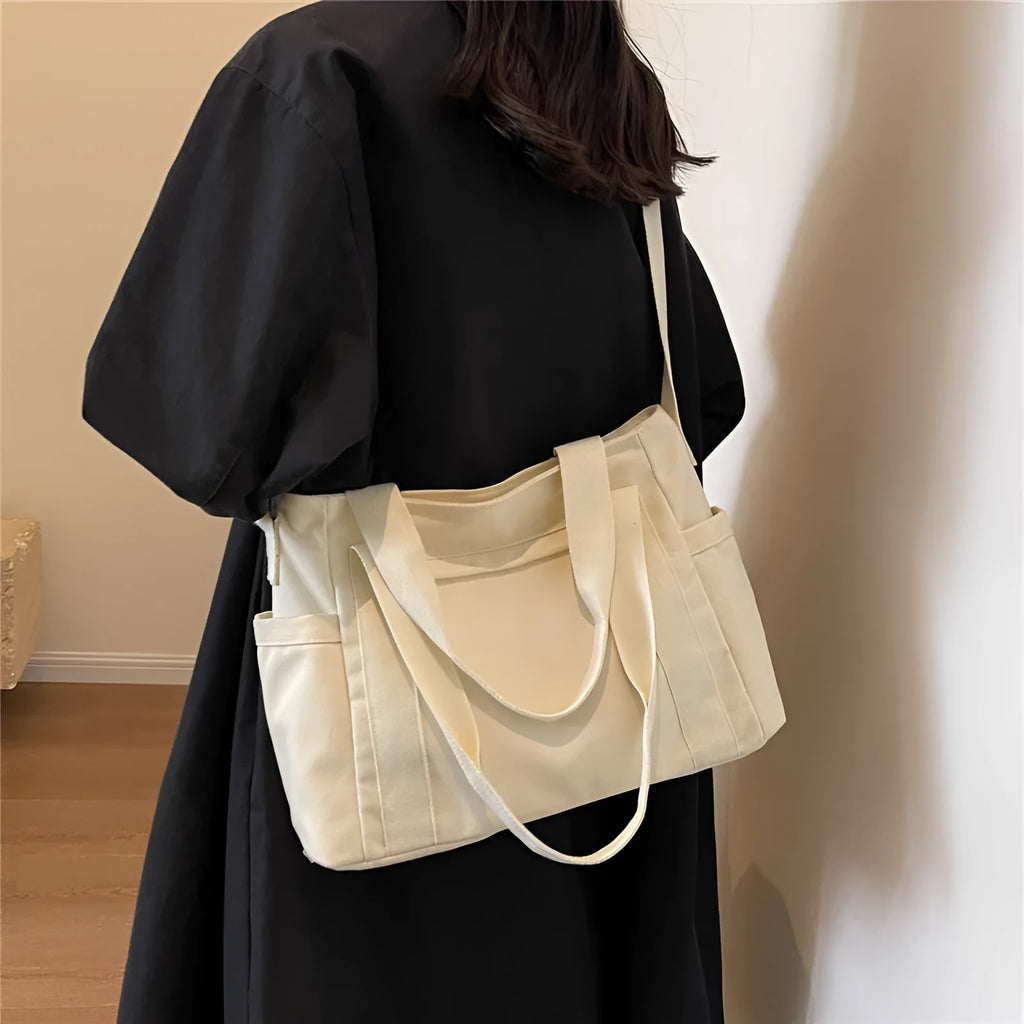 Polyester canvas shoulder bag in solid colour with internal mobile phone pocket organisation