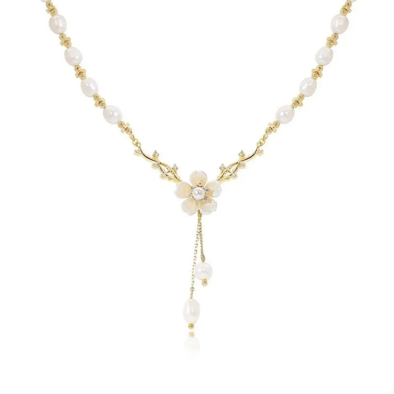 Women's alloy necklace with a white pearl flower and rose design pendant on a chain.