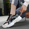 Women's white and black casual mesh sports shoes with a thick PU sole and buckle.