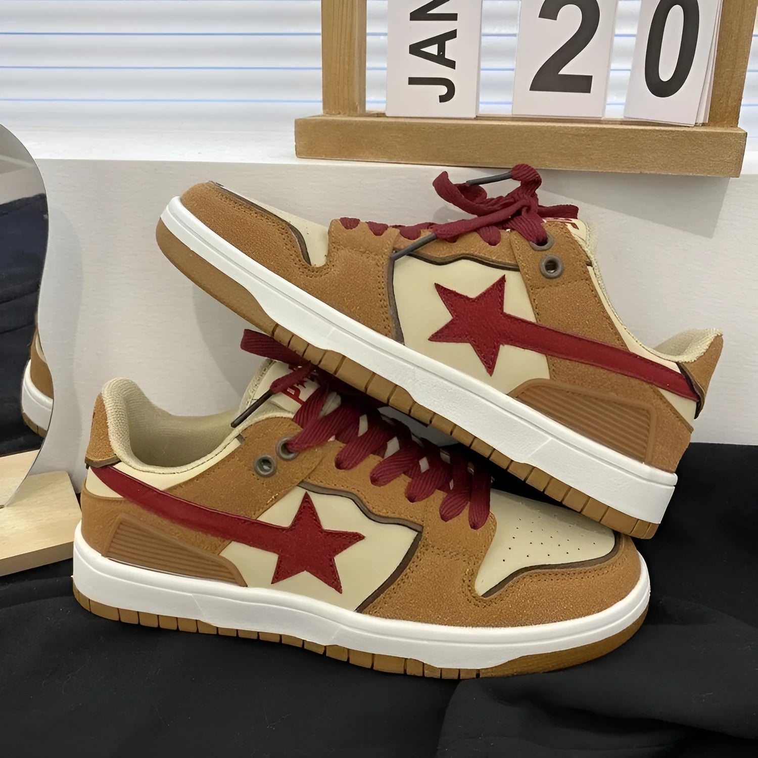 Brown low-top platform sneakers with sequins, lace-up fastening, and rubber sole on light background