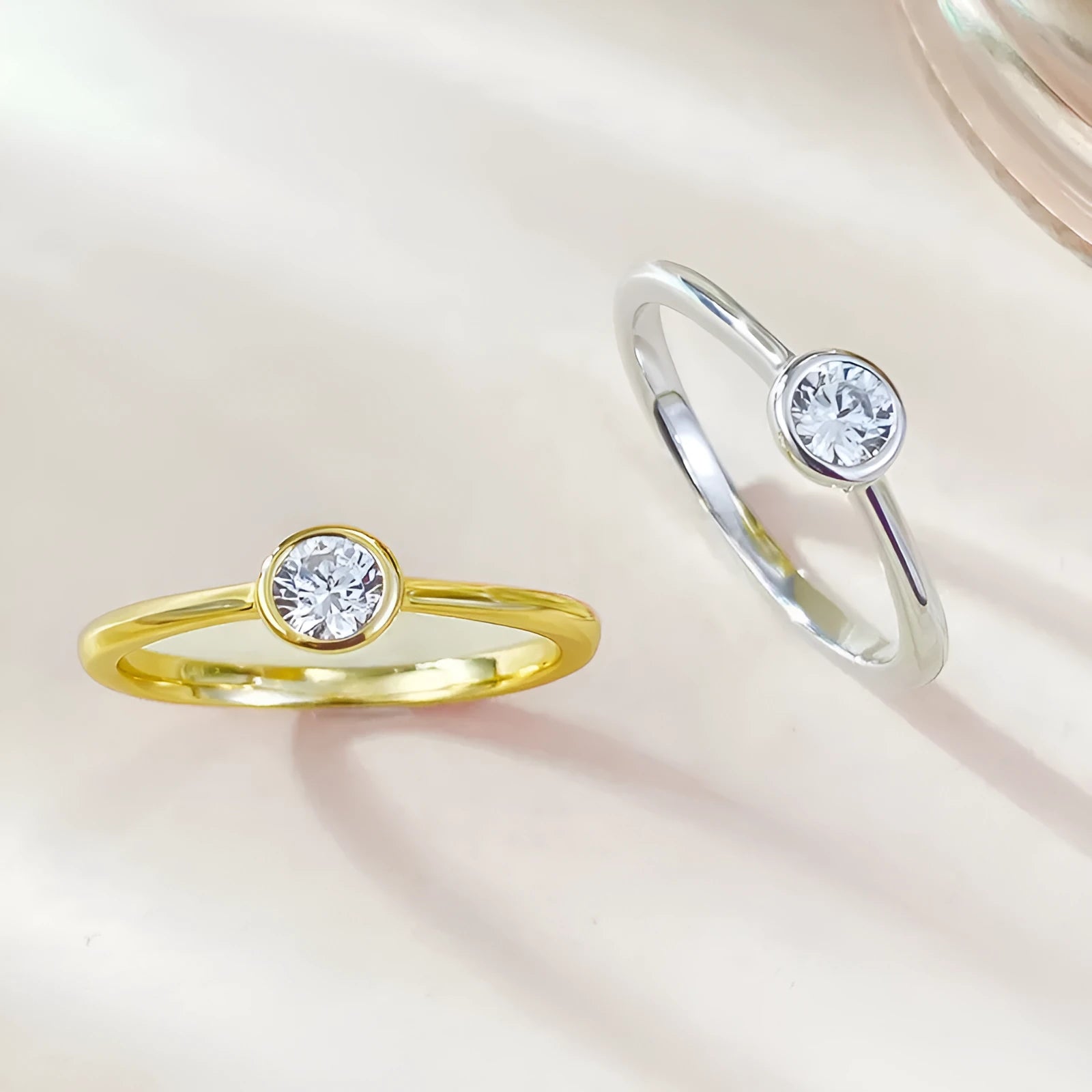 Minimalist crown-shaped silver ring with line detailing on a white background.
