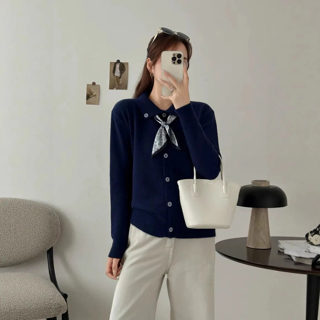 Women's beige cardigan sweater with a built-in lapel scarf collar and long sleeves.
