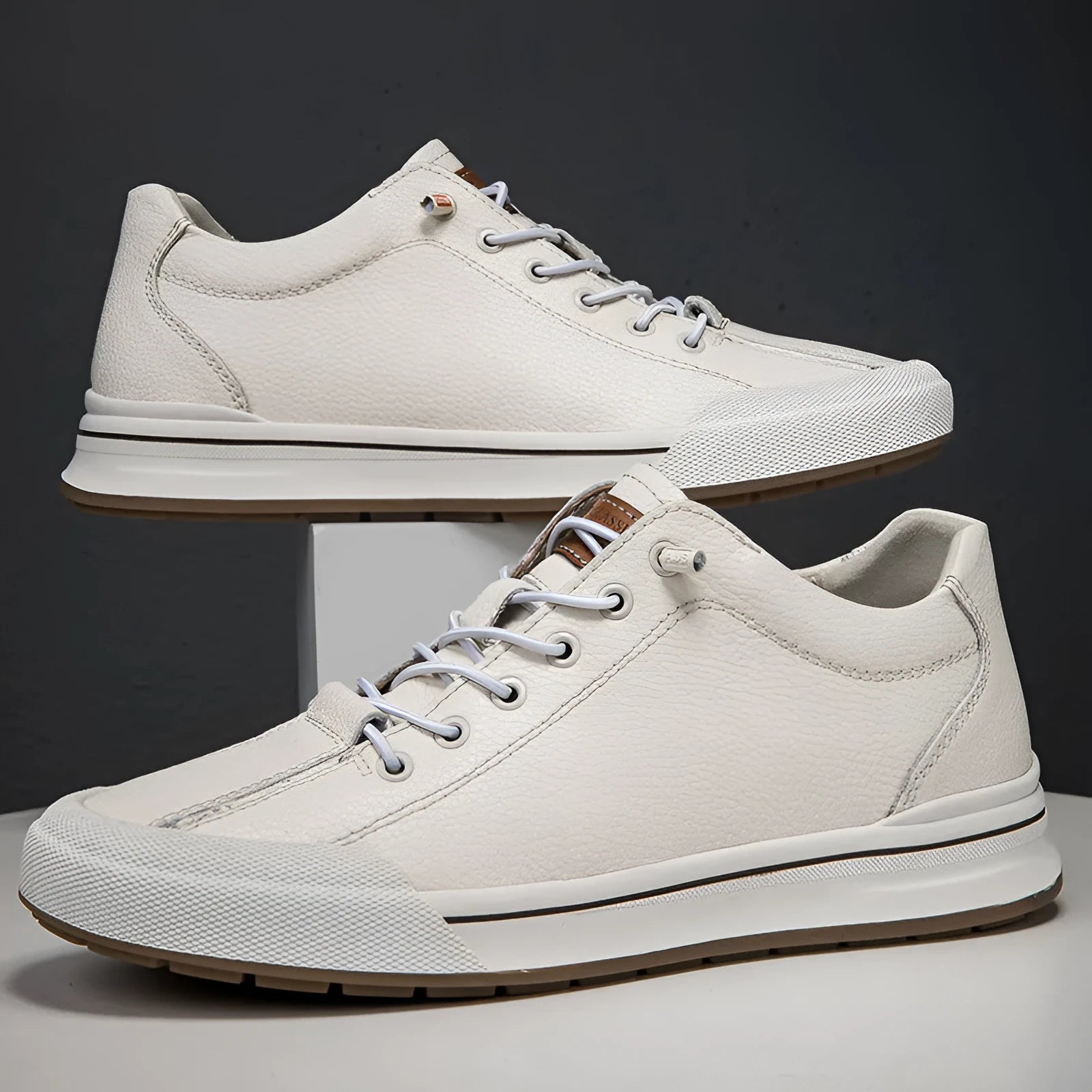 Men's white leather casual trainers with round toe and flat heel on size chart