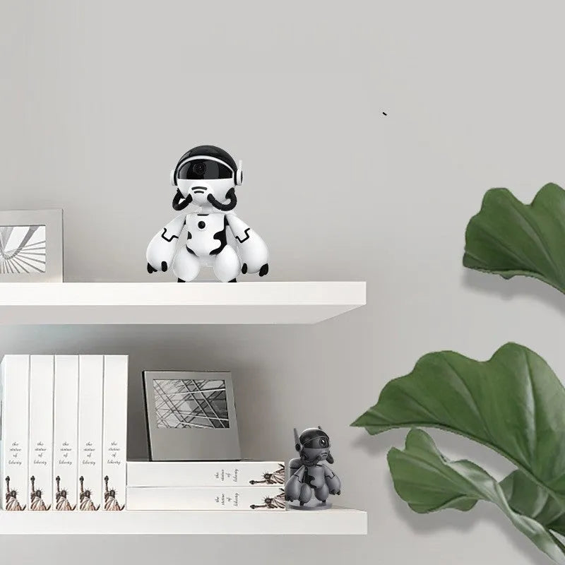 White wireless Space Robot indoor security camera with detachable base on a wooden surface