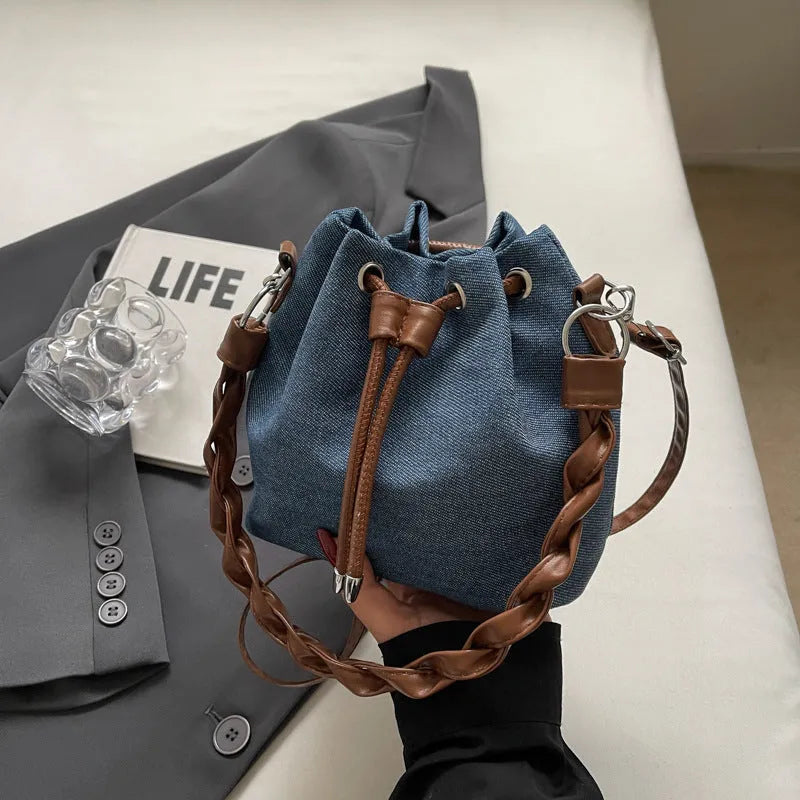 Blue one-shoulder cross body bucket bag with sandwich pocket compartments
