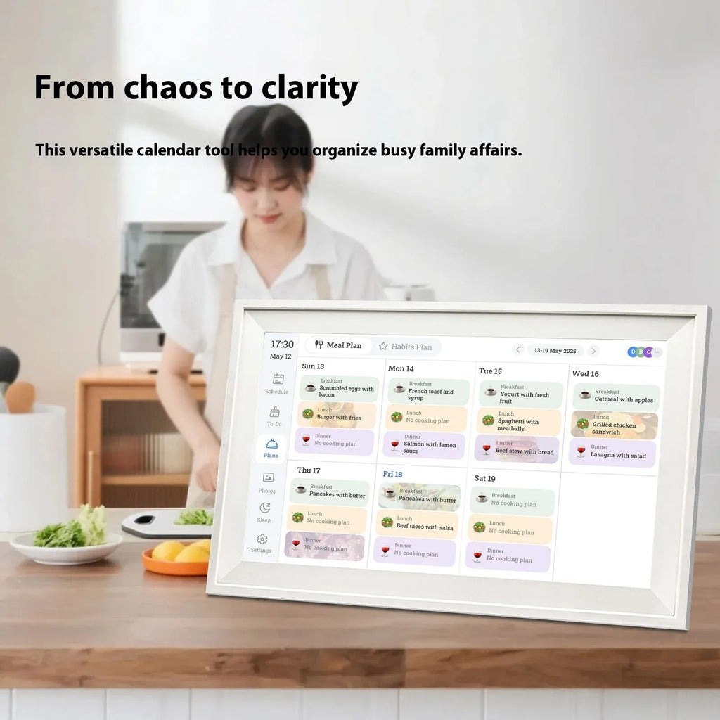 White 15.6 inch smart digital photo frame on a table with app control interface on a phone.