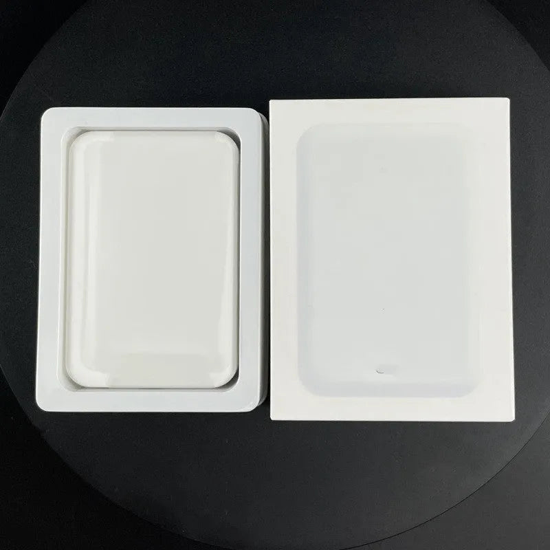 White portable magnetic wireless charger power bank showing compact design and charging surface