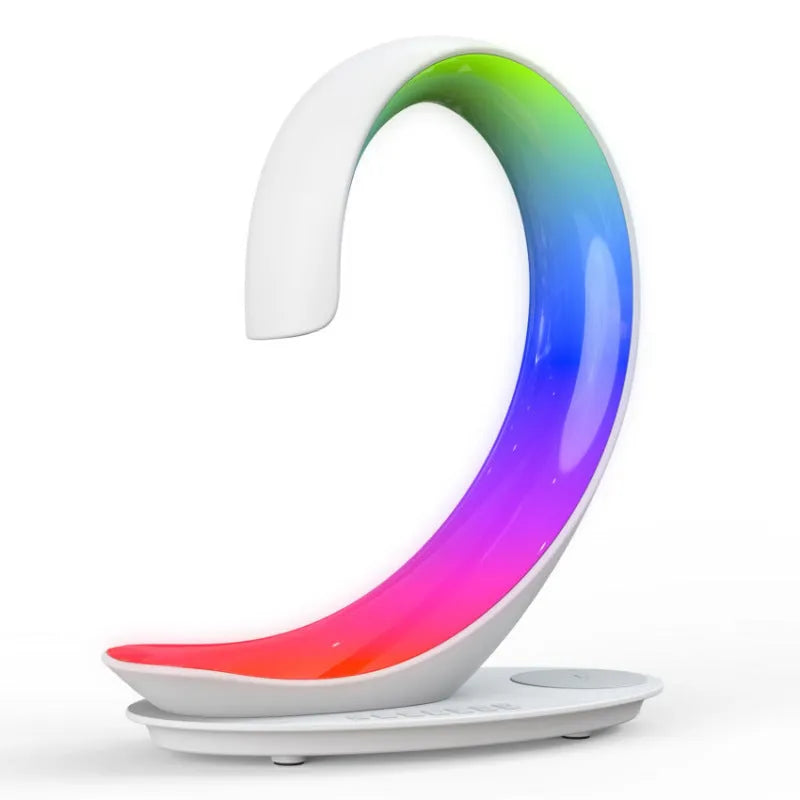 White swan-shaped desktop device with wireless charging surface, Bluetooth speaker, and colourful atmosphere lighting
