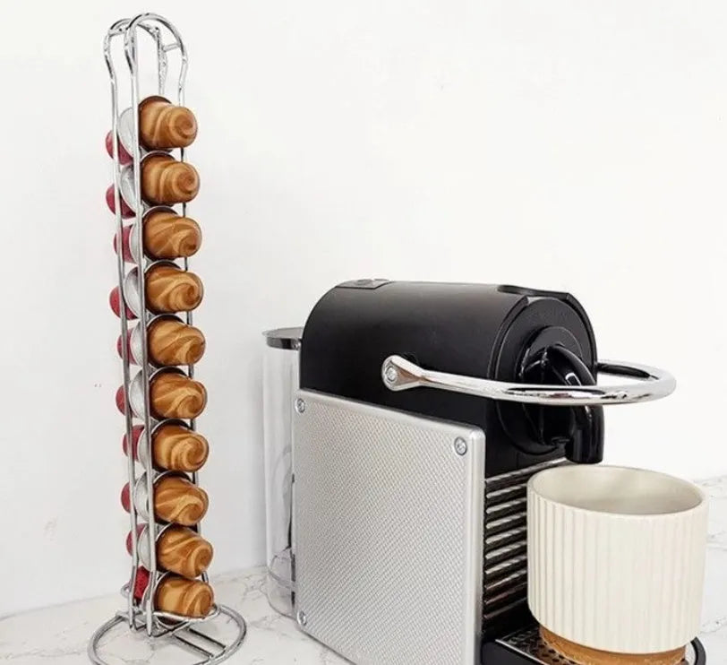 Black wrought iron coffee capsule storage rack holding coffee pods on kitchen counter