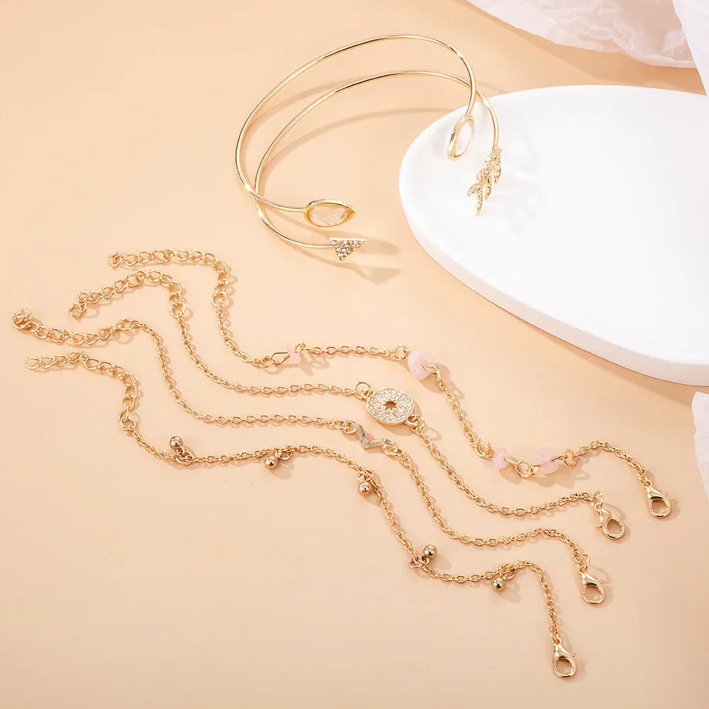 Six-piece zinc alloy women's bracelet set with golden spots, drill arrows, water droplets, and V-shaped links
