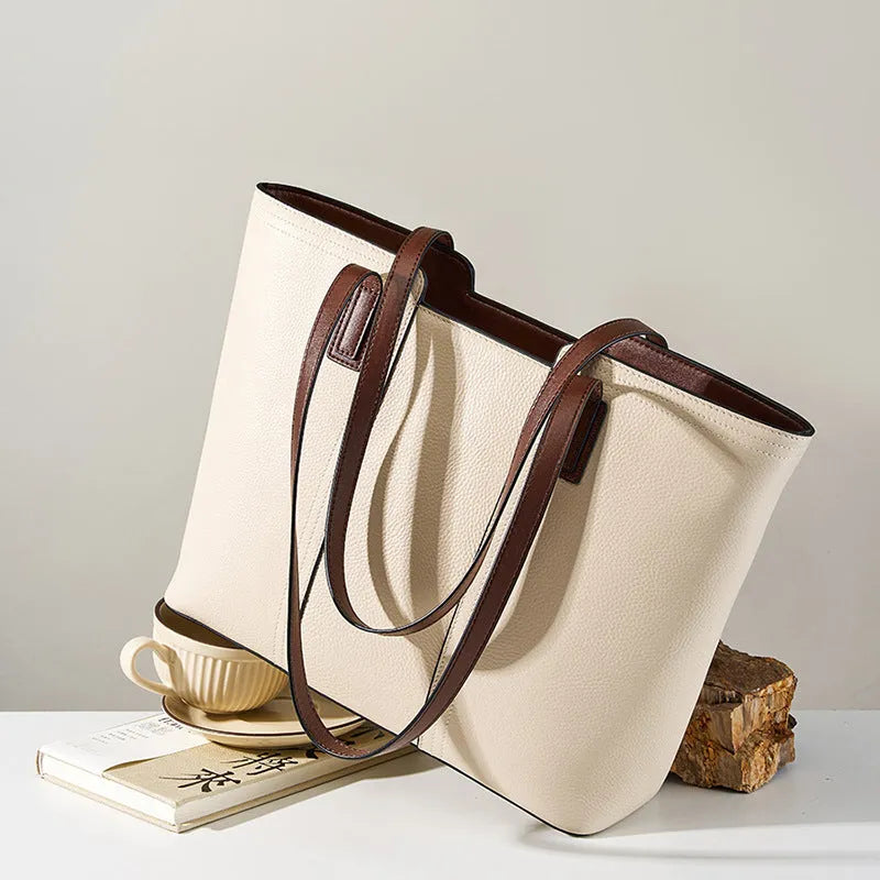 Women's black genuine cowhide leather commuter shoulder bag with horizontal square shape and multiple internal compartments