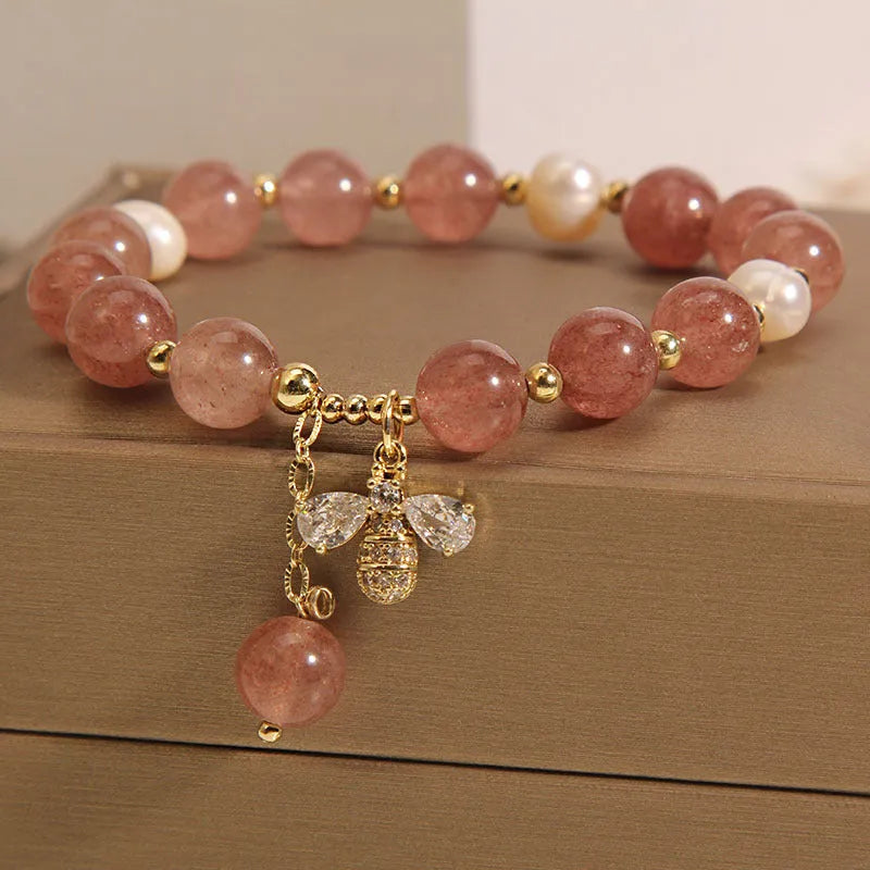 Pink strawberry quartz and white freshwater pearl bracelet with bee charm and zircon accents