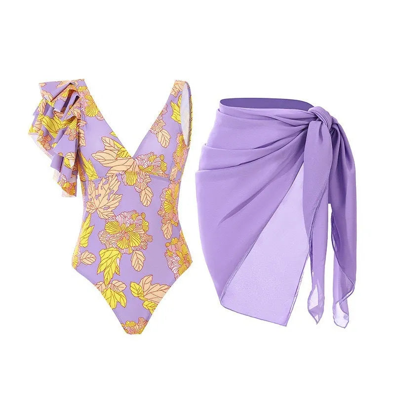 Women's solid colour one-piece swimsuit with spaghetti straps and a detachable skirt.
