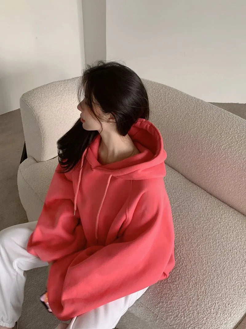 Watermelon red sleeveless women's hooded sweater made from mulberry silk, shown on a hanger.