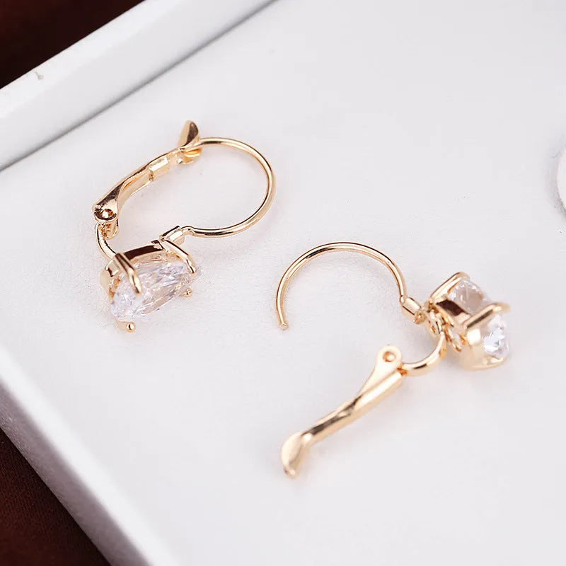 Drop-shaped copper earrings with platinum gem decoration in gold and platinum colour options