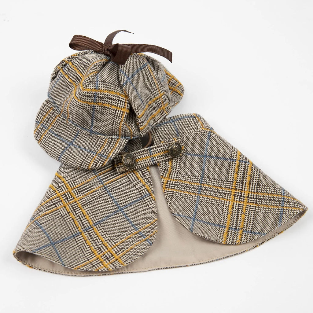 Camel-coloured detective-style cotton cloak for a small dog on a harness, showing the adjustable hat.