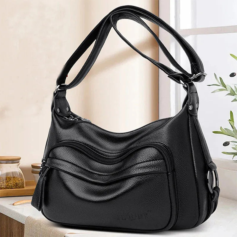 Blue women's large shoulder bag with crossbody strap showing internal mobile phone and certificate pockets