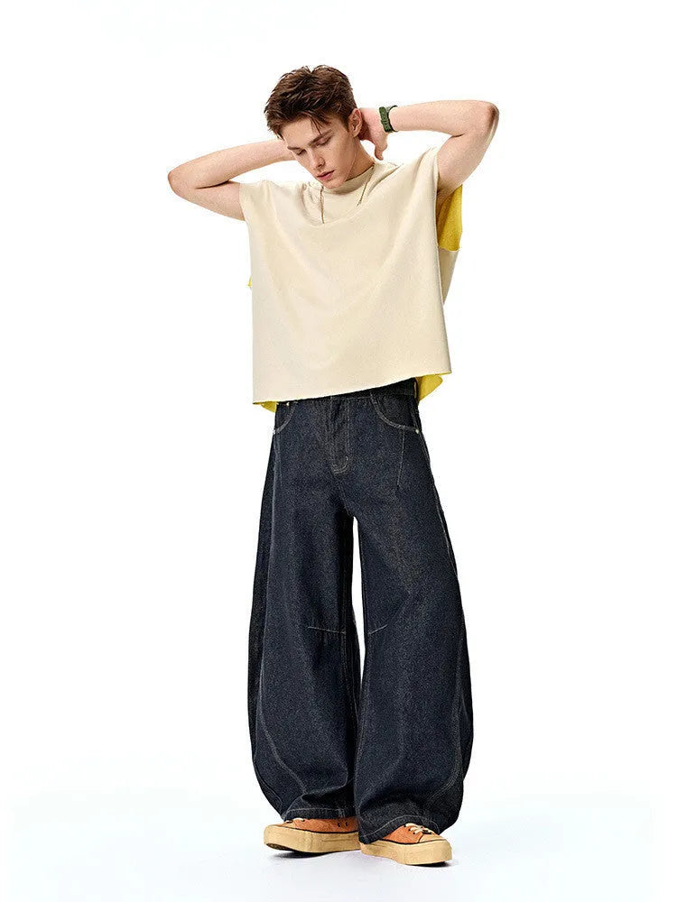 Men's wide leg denim trousers in original cow colour, showing mid waist and relaxed fit.