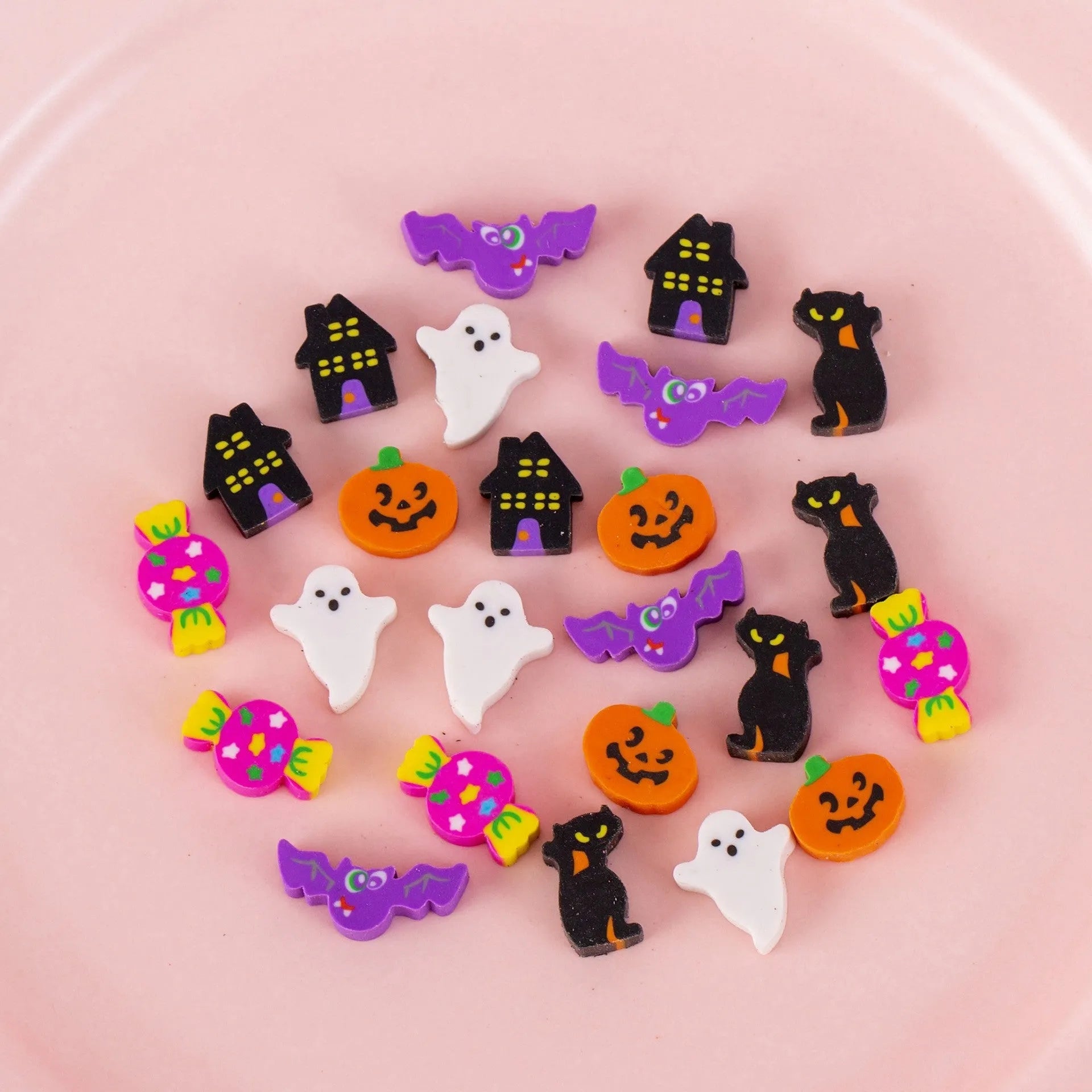 50 small colourful cartoon novelty erasers including fruit and animal shapes in a pearlescent film bag.