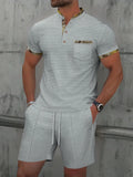 Men's grey sport suit with short sleeve polo collar top and matching shorts on mannequin