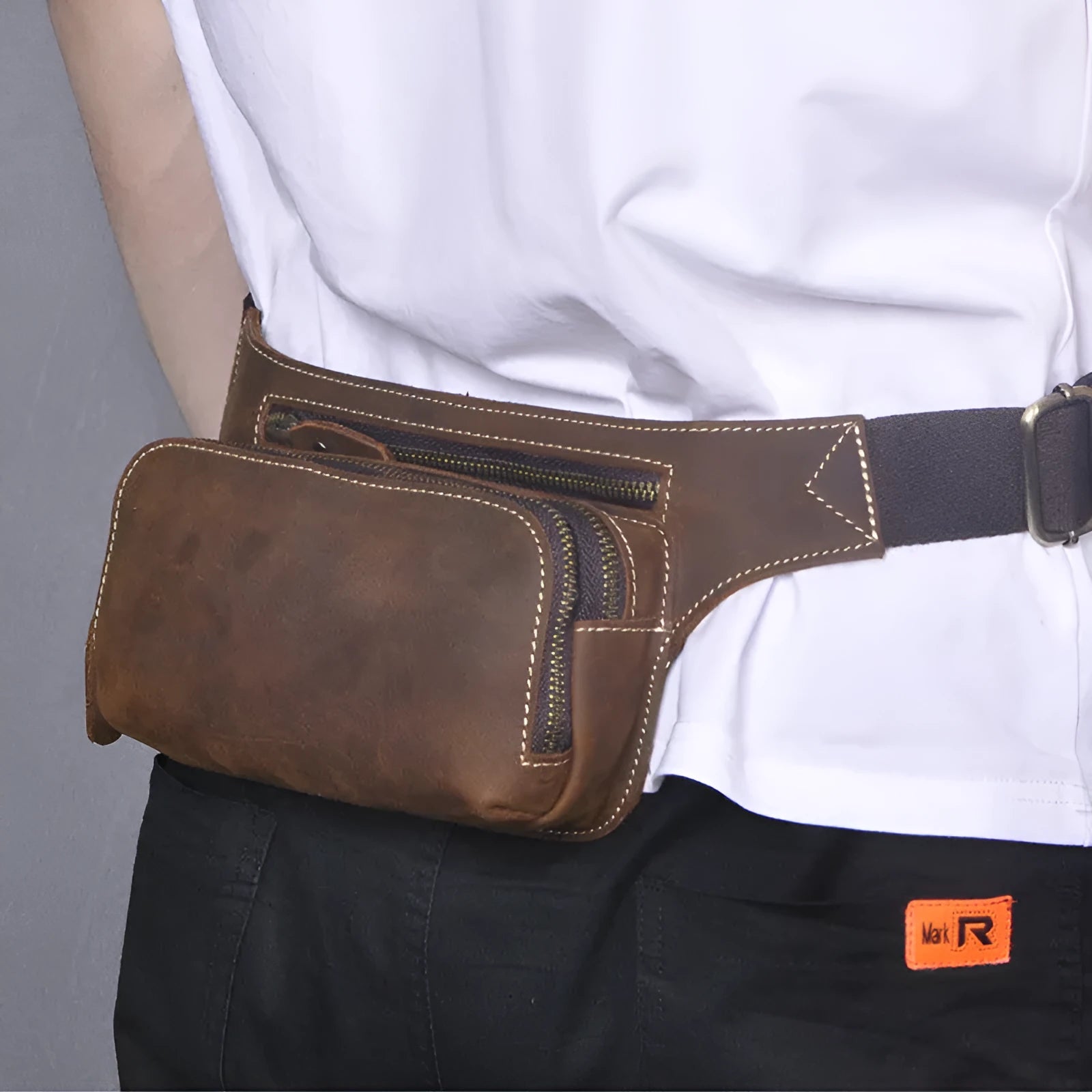 Brown top layer cowhide leather men's sports waist bag with pull closure.