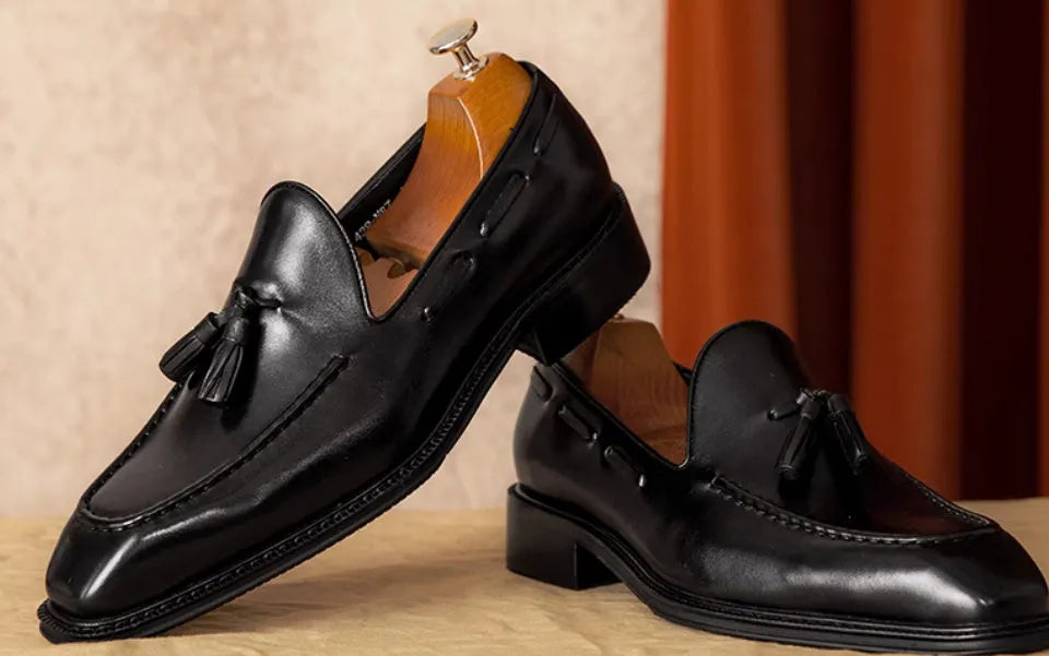 Men's black genuine leather loafers with fringe detailing and slip-on design