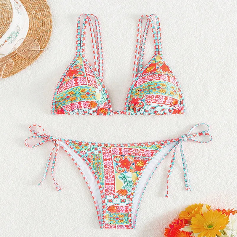 Women's lace-up split swimsuit in picture colour, showing backless brief design for swimming.